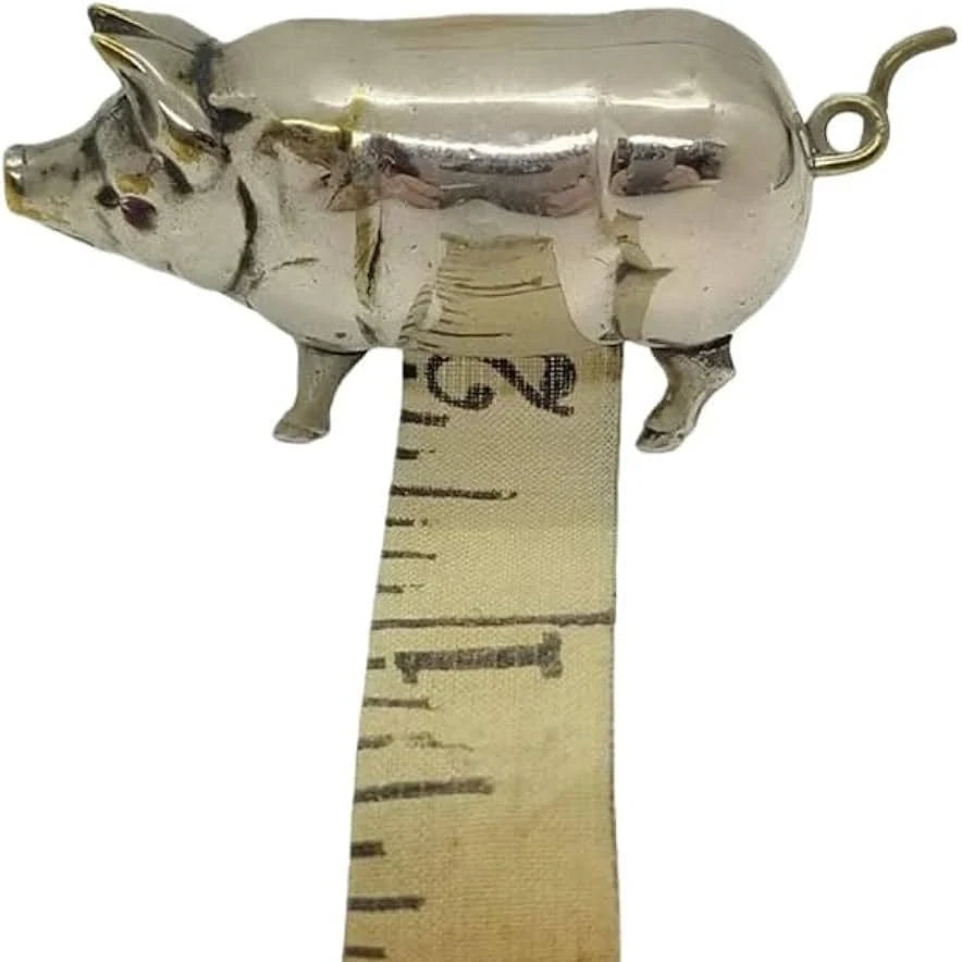Antique silver pig tape measure with measuring tape extended