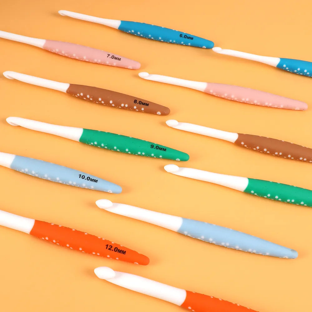 Six colorful ergonomic crochet hooks arranged together with visible size markings