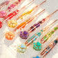 Close-up of colorful transparent floral resin crochet hooks with cat paw ends