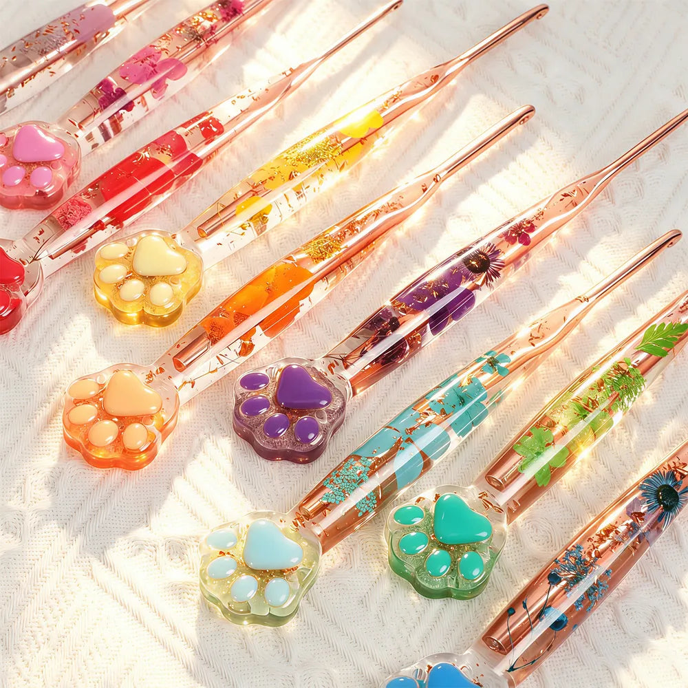 Close-up of colorful transparent floral resin crochet hooks with cat paw ends
