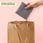 Compact gray circular knitting needle case being placed inside a handbag