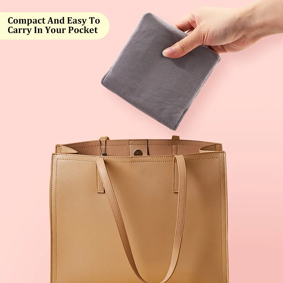 Compact gray circular knitting needle case being placed inside a handbag