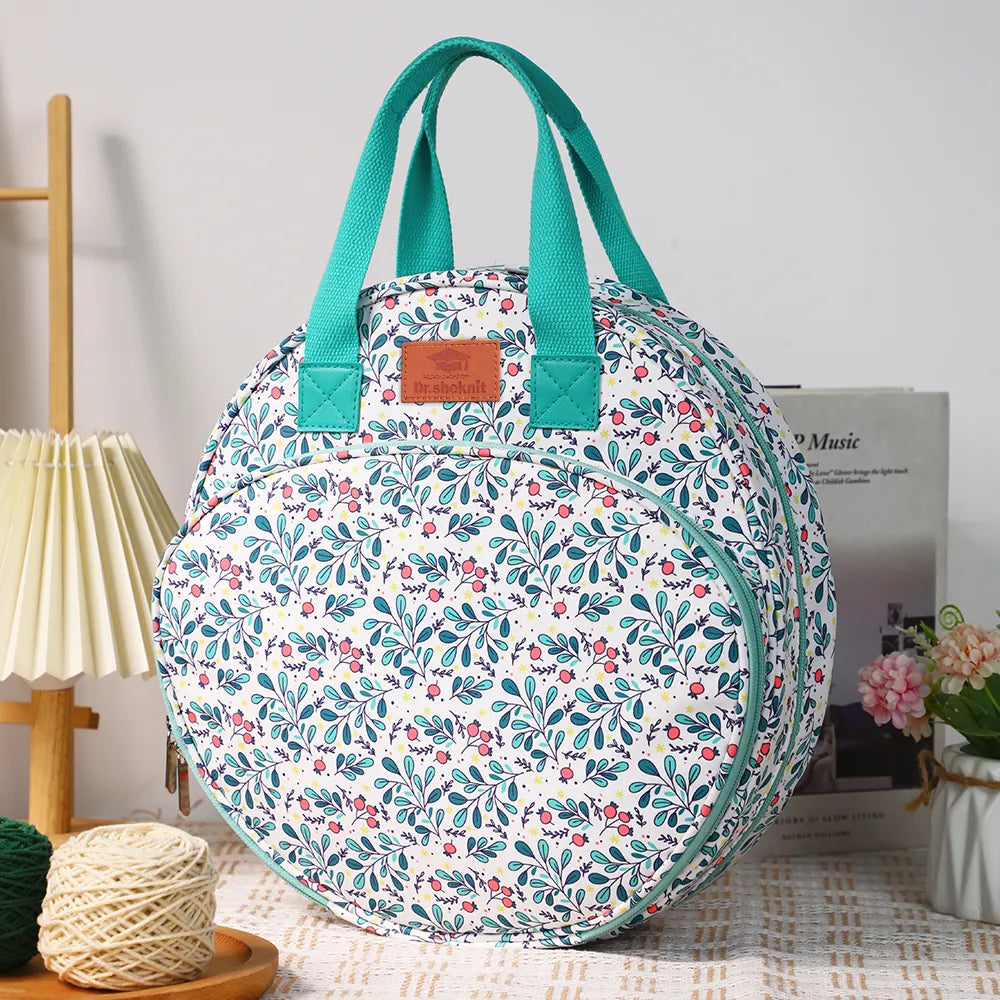 Floral embroidery project bag displayed with yarn in a craft room