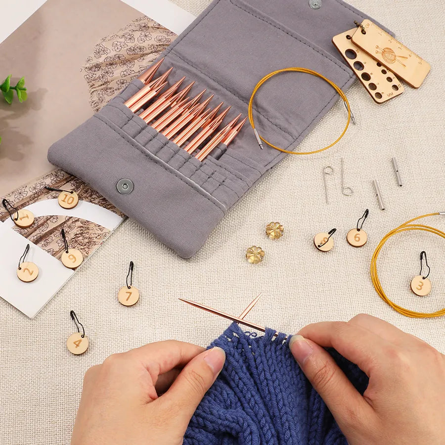 Rose gold-tone circular knitting needles used on a blue knitting project